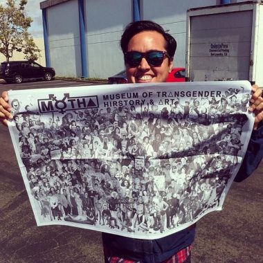 Chris E. Vargas holds a copy of his poster "Hiroes & Trancestors"